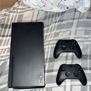 Sleek Black Gaming Console with Dual Controllers